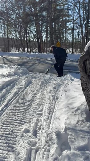 On road crossings on narrow trails where the big groomer can’t go, the snowbanks have to be shoveled. Here’s Mike Stickney shoveling the Route 2 snowbank on Trail 12 in Rumford Point. The shovel is stored in the tree cavity below the stop sign. | Rumford Polar Bears Snowmobile Club
