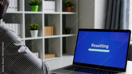 Person Resetting Laptop at Office
