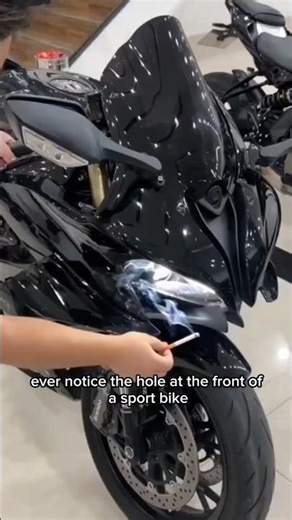What is the function of the hole in the front fairing of a motorbike?