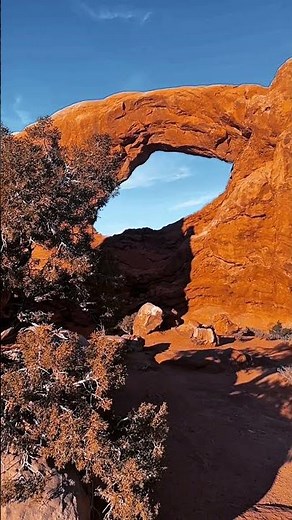 Red Sandstone Arch Framed By Desert Sky.