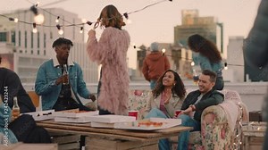 group of happy friends hanging out dancing together enjoying rooftop party at sunset drinking alcohol having fun on weekend celebration