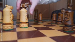 Two smart girls playing chess on a wooden chessboard close up