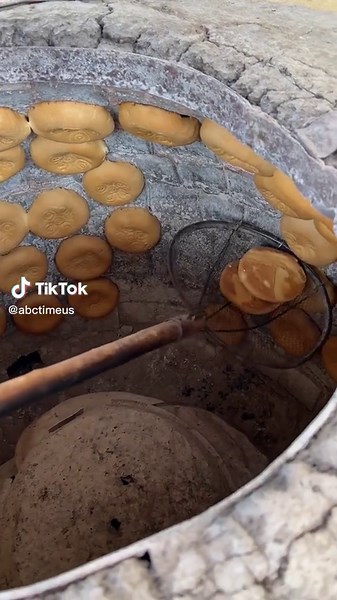 Traditional Bread-Making Process in a Rustic Oven