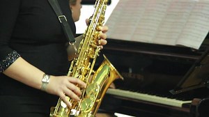 man's hands playing a wind instrument