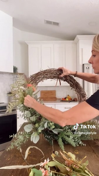 How to make a Spring Wreath. You will need: wire cutters, a mix of faux greenery and spring flowers, and a 24” grapevine wreath. Cut the greenery leaving 4” of stem. Tuck the greenery into the base of the wreath - then add flowers which can easily be changed out for seasons. I added a simple ribbon for hanging. So beautiful and so easy!💗💗💗 #springwreath #springwreathfrontdoor #springdecor #frontdoordecor #springporch