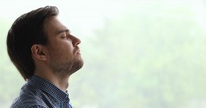 clip-1055363129-peaceful-man-pose-aside-near-window-background