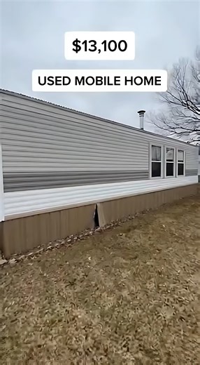 used mobile home priced at $13,100 The exterior looks simple but sits straight and level, with one damaged skirting panel that needs replacement. Inside, the flooring feels firm and the layout feels practical for daily living. The living area offers enough room for basic furniture, while the kitchen includes older cabinets with visible wear and working plumbing. The bedroom provides clean walls and solid flooring, and the bathroom functions properly with only a loose sink faucet needing attentio
