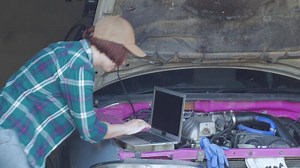 Female mechanic fixing car in a garage