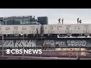 Subway surfers seen atop train crossing bridge into Brooklyn