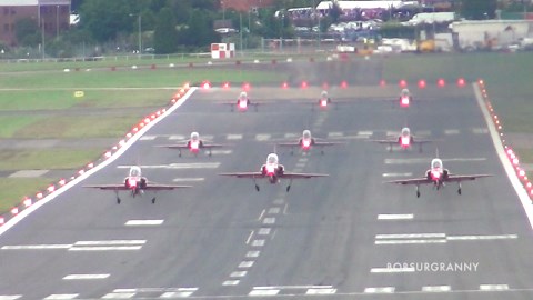 Watch the Red Arrows launch head on with red white and blue smoke