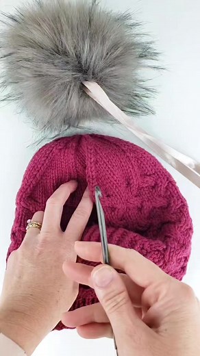 Our new pom poms come with a ribbon to attach them! Just use a crochet hook to thread the ribbon through and then tie it. And when you're ready to move it to another hat, just untie and switch it to your next hat! Like this reel if you have a hat this pom pom would look great on 😀 | Twice Sheared Sheep