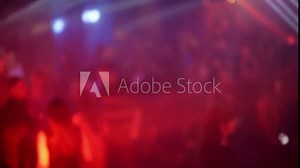 crowd of people dancing on the dance floor of a night club under the light of colored spotlights and lasers