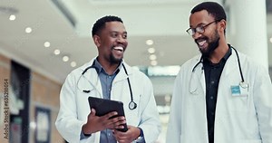 Doctors, tablet and talking in a hospital for medical planning, discussion and internet. Healthcare men working together with collaboration, teamwork or technology for database, schedule or advice