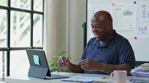 Creative African American businessman using laptop computer in office, chatting online, thinking of business solution in planning. Contact online mobile work, use strategies in marketing.