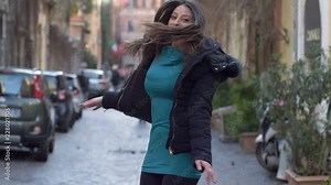 Carefree happy woman jumping in the street. Joy,fun, happiness- slow motion