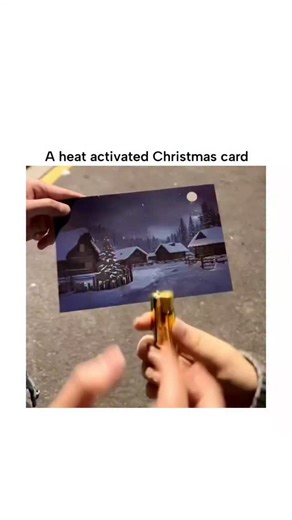 MemeFiore on Instagram: "The post features a 13-second video of a thermochromic Christmas card depicting a dark snowy village; applying heat from a butane lighter reveals hidden illuminated windows and tree lights, creating a "magical" glow effect that resets after cooling. Thermochromic inks in the card use leuco dyes that turn transparent at around 30°C, exposing underlying colorful prints; this reversible process, based on molecular structure changes, makes the card reusable and safe for brie