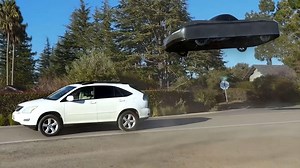 Flying Car Prototype Flies Over a Stopped Car