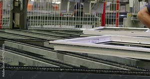 The operator works on a robotic conveyor for the production of plastic windows