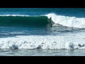 Swamis beach, Encinitas, CA, near San Diego - 12/30/23: Surfers ride 10-14' waves
