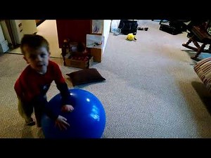 kid bouncing on yoga ball