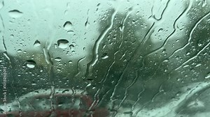 Raindrops on the glass create a harmonious backdrop, blending with the reflections.
