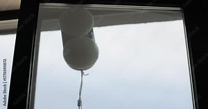 Close up automatic window cleaning robot operating on residential window. Simplicity and convenience of window cleaning.