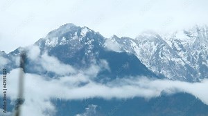 Time lapse of the cloud stream in front of the snow covered mountain peak of the Himalayan mountain range during the snow storm at Manali in Himachal Pradesh, India. Clouds during snow storm timelapse