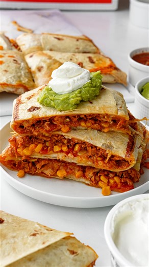 Finally trying the VIRAL Sheet Pan Quesadillas! These are perfect for the big game, or any weeknight dinner. I used @CuisineSolutions Sous Vide Chicken Taco Meat which added so much flavor and comes ready-to-eat which is always clutch! Their sous vide lineup of products is always a lifesaver giving me more time to enjoy what I make vs. time spent making it. Check out the recipe below and let me know what you think! Ingredients 2 lbs Cuisine Solutions Sous Vide Chicken Taco Meat 1 can corn, drain