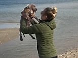 Elyse Knowles does strange squat workout using her dog as a weight