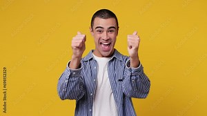 Back rear view young middle eastern man he wear blue shirt white t-shirt turn around camera showing thumbs up sign like gesture isolated on plain yellow background studio portrait. Lifestyle concept