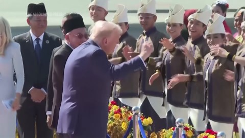 Trump showcases trademark campaign dance moves as performers welcome him on arrival in Malaysia