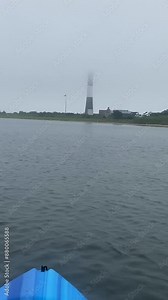 View of the Fire Island Lighthouse in the fog from the Great South Bay while floating on a kayak.