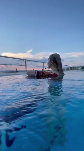 Enchanting Twilight Pool Scene with Long Blonde Hair