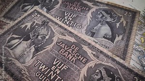 25 guilder Indonesian banknote depicting Javanese puppets from the Dutch colonial era.