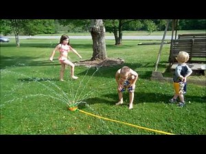 Playing in the water sprinkler