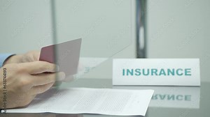 Insurer checking passport and stamping insurance agreement