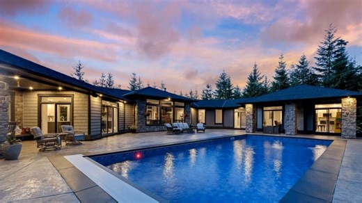 Presented by Layne Britton eXp Luxury layne.britton@exprealty.com 250-588-6011 Exquisite home on a fully fenced, private Shawnigan acreage. Custom-built with an open layout, soaring ceilings, and walls of glass. The kitchen and dining flow to a south-facing patio and pool with power cover perfect for entertaining. The main bedroom offers a 5-piece ensuite, walk-in closet, and private patio with gas fireplace. 4 beds, 5 baths, guest suite, pool room, and 1, 800 sqft of patio with wood-fired cooki