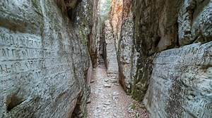 Narrow canyon walkthrough: exploring ancient rock pathways and natural formations