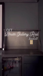 Brass gallery rails add so much character to a shelf! I went with a double rail here, so I needed twice as many rods as a single rail design. Check my latest blog post on my website for detailed info on planning, install, and sources! Another DIY (or two) in here before the full reveal, but I’m loving this corner of the home theater! #hometheater #drybar #popcornbar #brassgalleryrail #brassrailing #polishedbrass | Emily Made Home