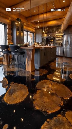 This log cabin floor combines raw wood slices with high-gloss epoxy resin to create a completely unique surface that's both functional and breathtaking. Each wood section preserves decades of natural growth patterns, encased in durable black resin. This floor isn't just beautiful—it's built to last decades while telling a natural story beneath your feet. Perfect for homeowners who want their renovation to make a statement. | ReBuilt
