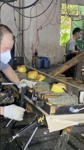 a man using a press machine to press a material