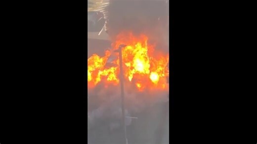 Wild moment burning car explodes in parking lot