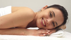 Joyful girl relaxes on the massage table