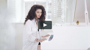 4K Portrait of beautiful woman playing piano in elegant apartment | Vimeo Stock