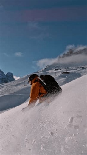 Off Piste Skier Running Down. Super Slow Motion, 1000 fps. Skiing on Free Ride off Piste Slope in European Dolomites Mountains, Italy. Vertical Aspect Ratio.