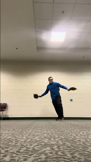 Ambidextrous wallball with pickle ball paddles from front of me POV using in tennis ball