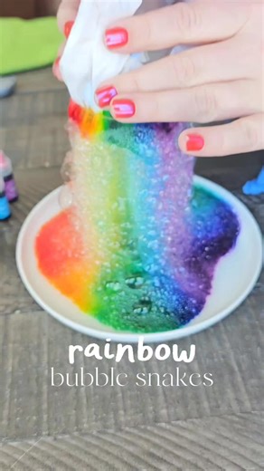 RAINBOW BUBBLE SNAKES🌈🫧 Cut a water bottle in half. Put a baby wipe over top and secure with a rubberband. Make a rainbow with food coloring on top. On a plate, add about 1 tbsp dish soap and 1/4 cup water. Press the bottle to the soap and blow lifting up! 🚨 Wear gloves this stains🤣 | Crafty Morning