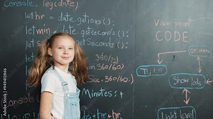 Caucasian girl writing blackboard and turnaround to looking at camera while standing at board with engineering prompt or coding, programing system written in STEM technology classroom. Erudition.