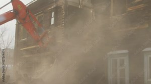 Slow motion. The work of special equipment for the demolition of old buildings. Demolition of dilapidated old house. Close-up bucket destroys the wall two-storey house. The destruction of the building