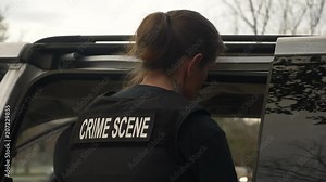 A female crime scene investigator working a crime scene to solve a homicide mystery.